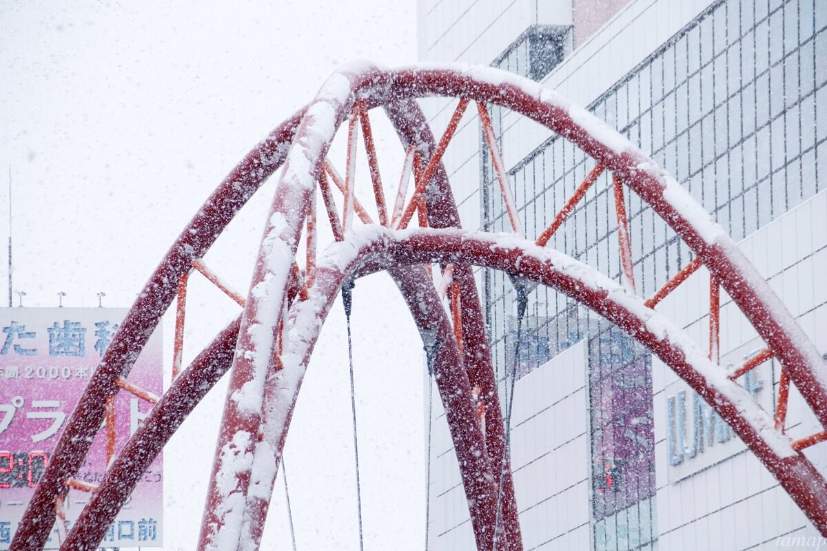 立川駅の赤いアーチ状のオブジェの雪
